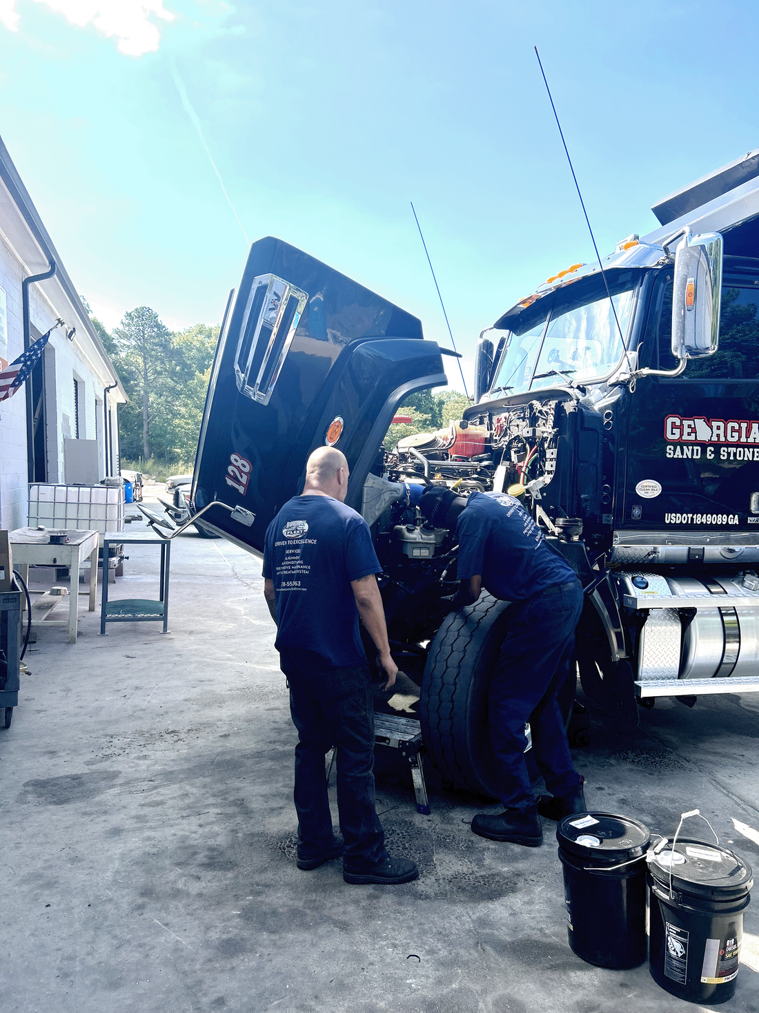 Donnie and employee working on tractor trailer engine